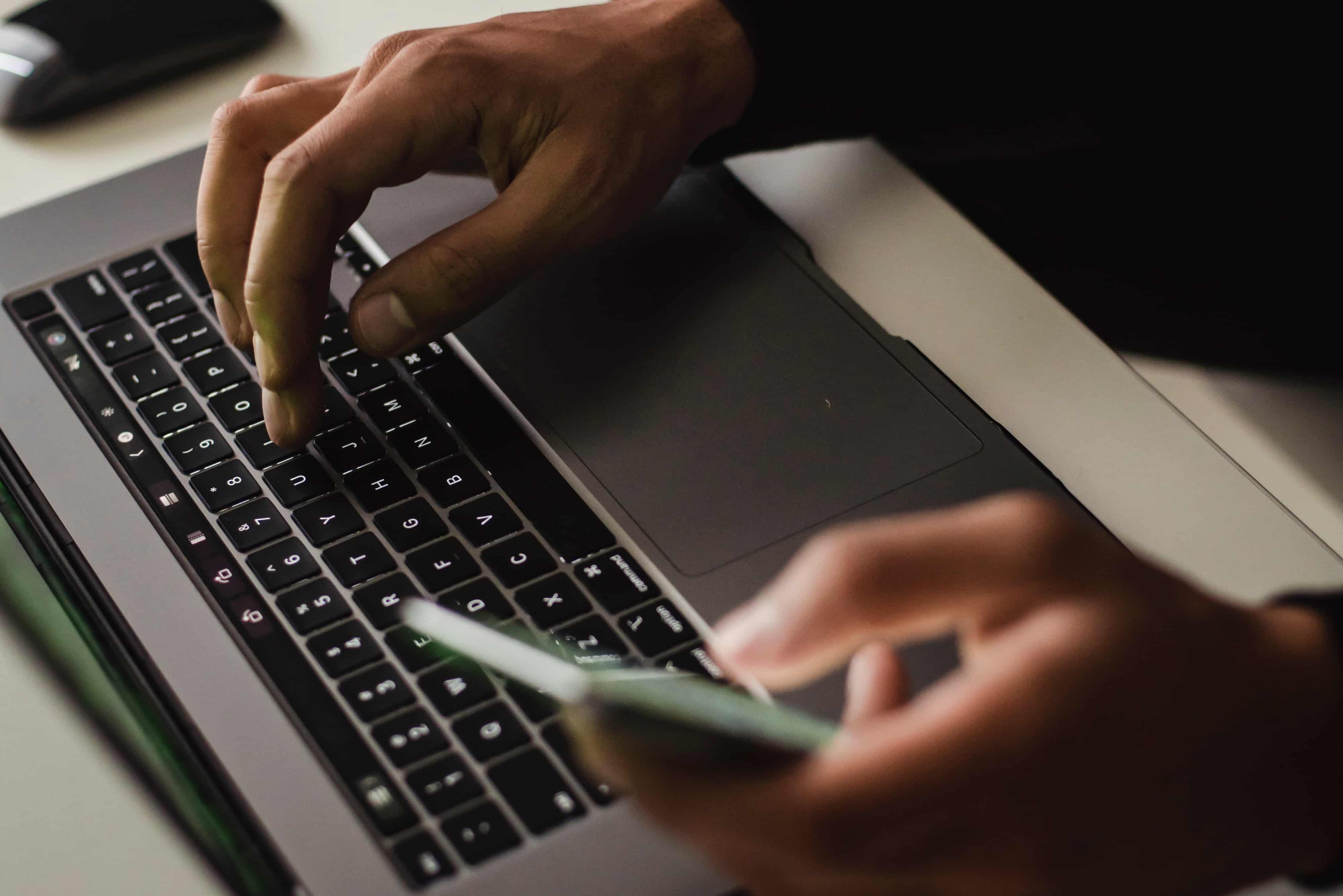 Person using laptop keyboard
